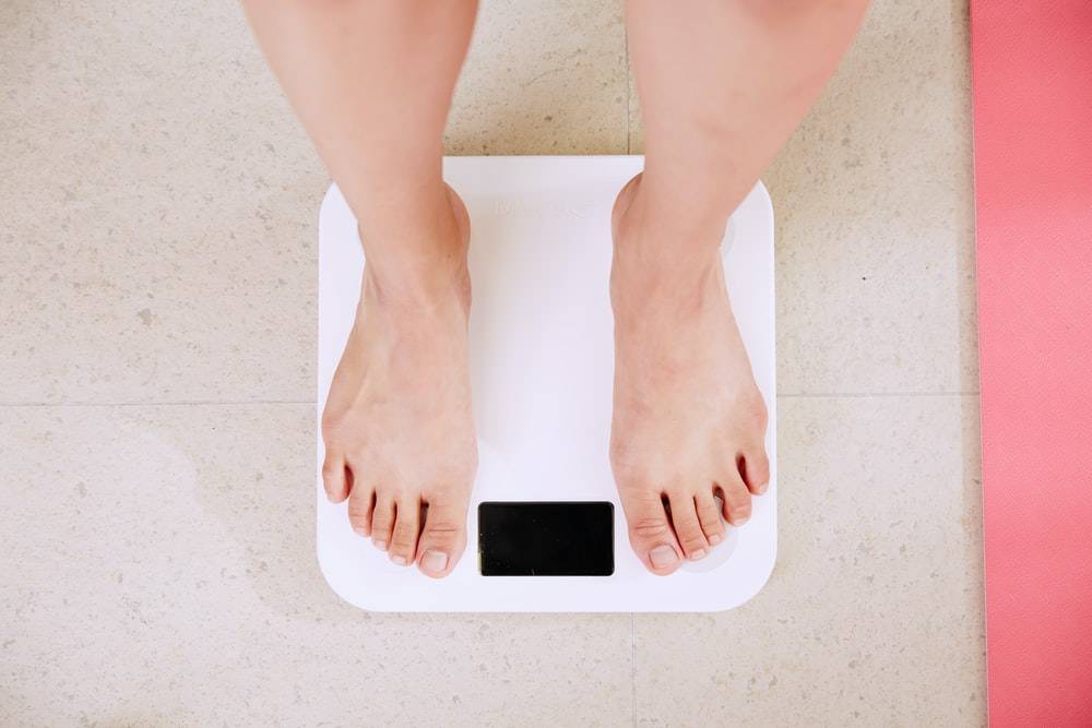 A person standing on a weighing scale 