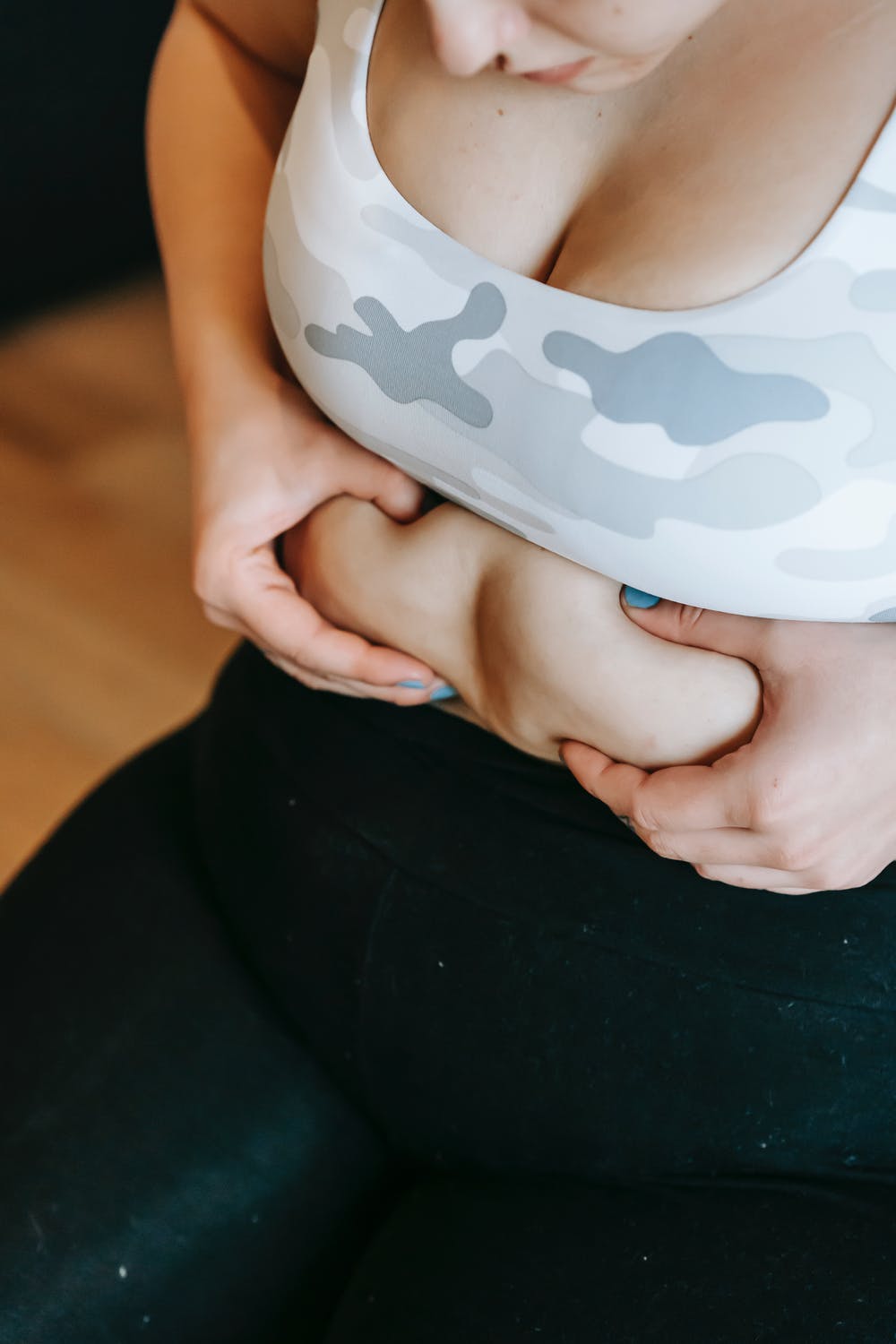 a woman holding abdominal cellulite